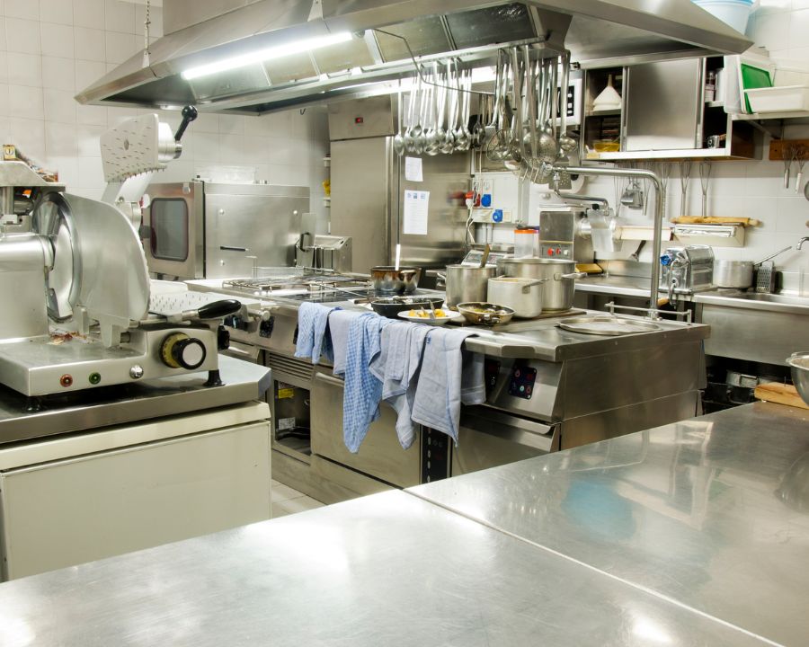 Image of a kitchen with stainless steel appliances, granite countertops, and white cabinets.